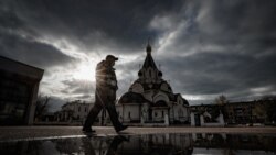 RUSSIA -- A policeman wearing a protective mask patrols a street near Orthodox church during pandemic of SARS-CoV-2 coronavirus in Moscow, October 26, 2020